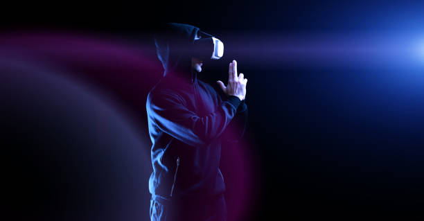 istock Vr goggles virtual reality. Young man in digital helmet for 3d virtual reality game on dark background. Study and virtual world in 3D simulation. 1382849555