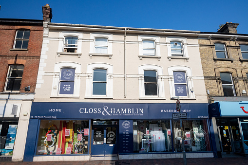 Closs & Hamblin Fabric Store on Camden Road at Royal Tunbridge Wells in Kent, England. Other shops are visible.