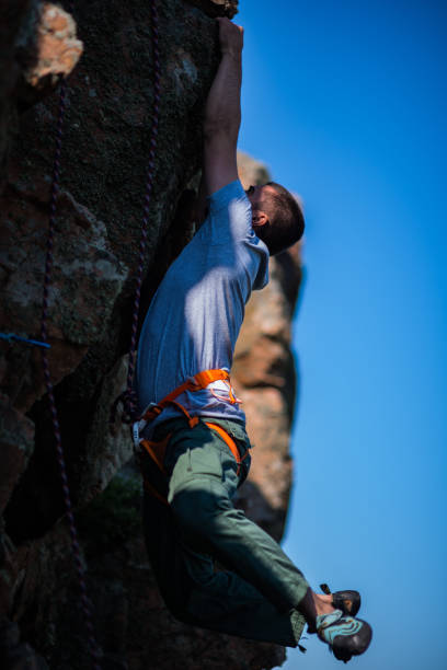 istock Rock climber climbing up a steep piece of mountain 1382860953
