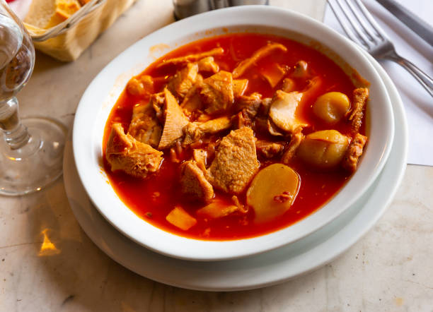Traditional French dish, provencale tripes, served in bowl with serving pieces.