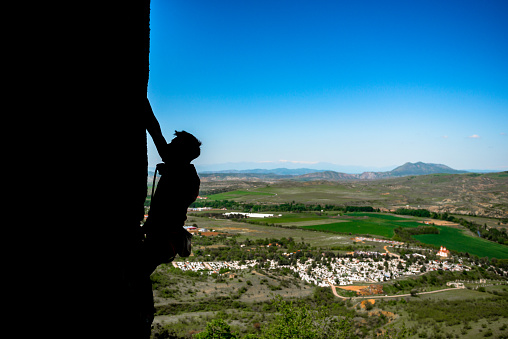 Climbing rock climber free climbing strong fit man fitness sport model hanging on vertical cliff