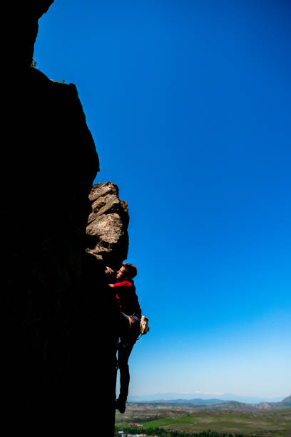 istock Rock climbing. A man climbs on the rocks 1382864202
