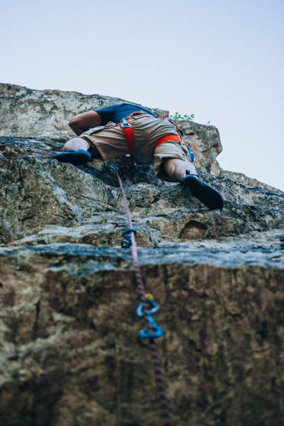 istock Rock climber battles his way up 1382868861