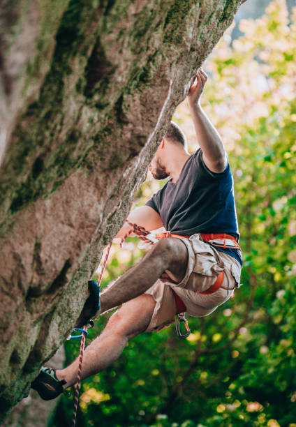 istock Rock climber climbing up a cliff 1382868890