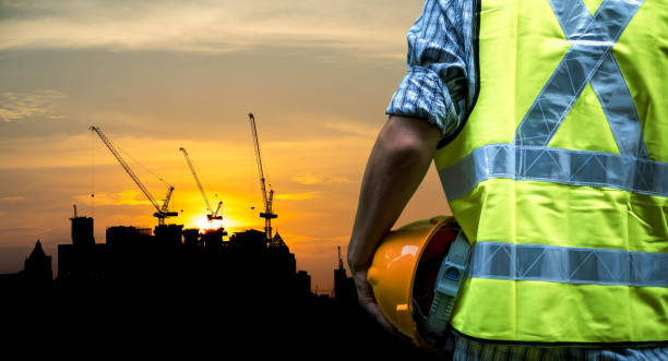 istock Engineering man standing with yellow safety helmet isolated on white background 1382879755