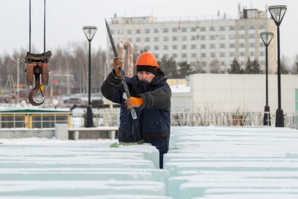 istock An assembly worker tries to push the ice slabs apart with a crowbar 1382880267