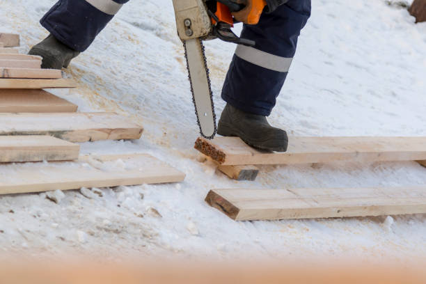 istock Fitter with a gasoline saw cuts long planks 1382884206