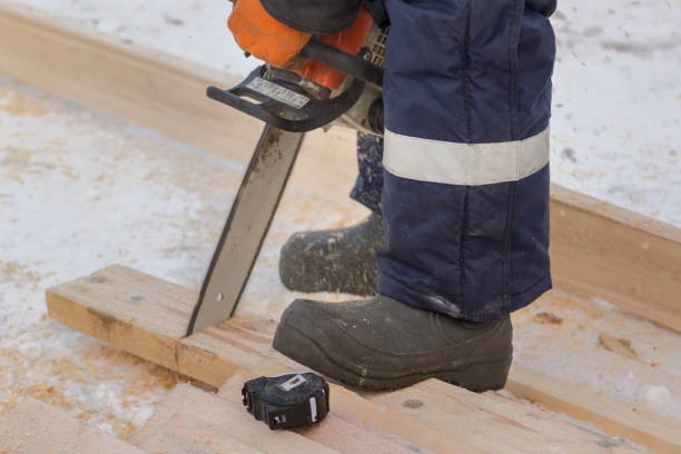 istock Fitter with a gasoline saw cuts long planks 1382884806