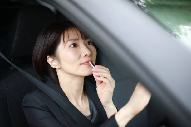 istock Woman making up in the car 1382887908