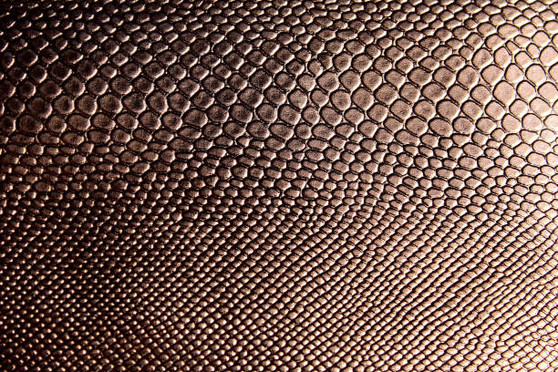 istock Texture of shiny artificial leather under brown snake 1382894039