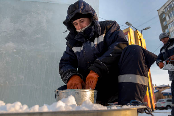 istock Fitter in a blue jacket at an iron trough with snow 1382900562