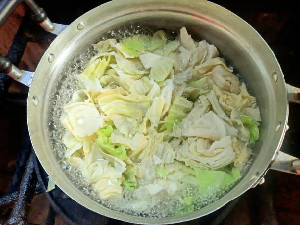 Cooking Cabbage vegetable Soup - food preparation. stock photo