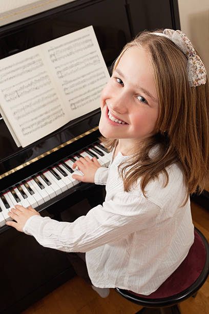 istock Smiling girl playing her piano 138290163