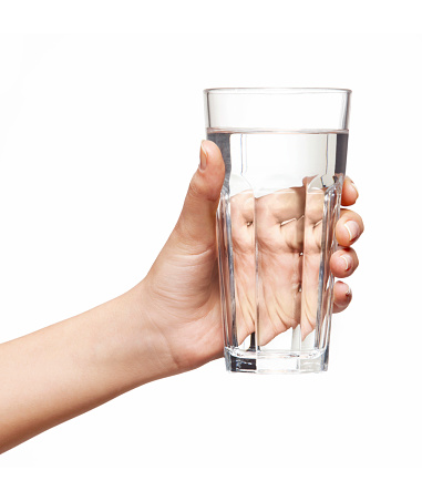 female hand holding a glass of water