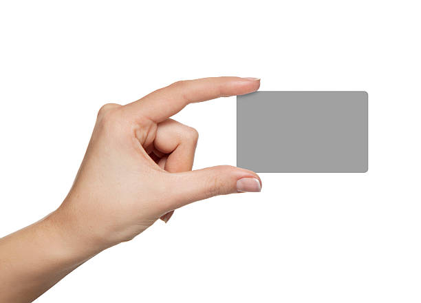 blank credit card in a female hand stock photo