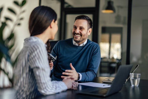 istock Smiling caucasian man, bonding with his coworker, having a conversation. 1382907129