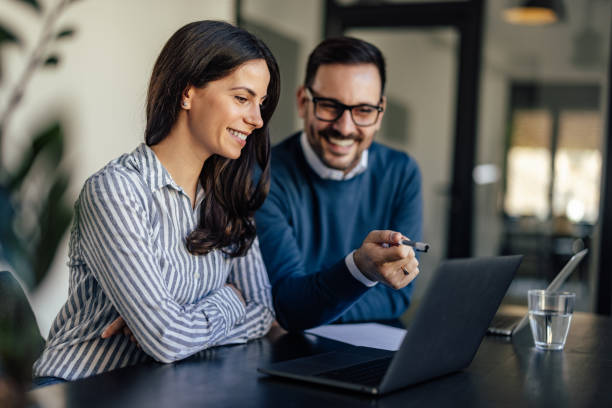 istock Helpful caucasian man, giving pointers to his female coworker. 1382907130