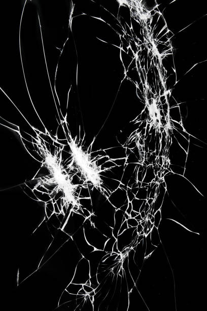 istock Broken glass on smartphone screen. Cracks on a black background 1382907222