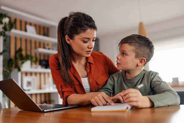 istock Hardworking female tutor, explaining the question to her young student. 1382907452