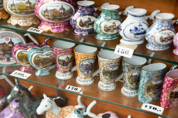 KARLOVY VARY, CZECH REPUBLIC - OCTOBER 10, 2019: Famous souvenirs of Karlovy Vary mugs and cups for mineral water displayed in shop for sale