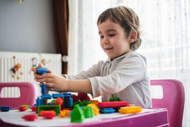 istock Child Boy Playing With Toys At Home 1382912442
