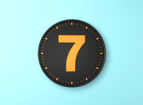 Number 7 Over Black wall clock on blue background. Time concept.