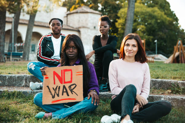 istock Group of people marching against War 1382926804