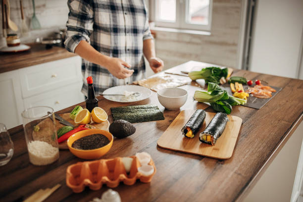 istock Man preparing sushi at home 1382928372