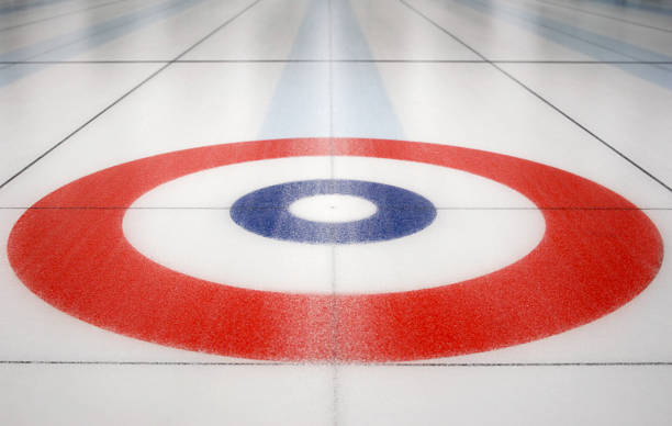 Curling House inside ice shed An empty house from the sport curling on a sheet of ice in a curling arena. *NOTE* that the ice is NOT smooth and has a rough, uneven texture. Focus is on button, or middle of the house. curling stock pictures, royalty-free photos & images