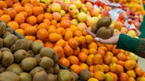 istock Human Hand Holding Kiwi 1382935426