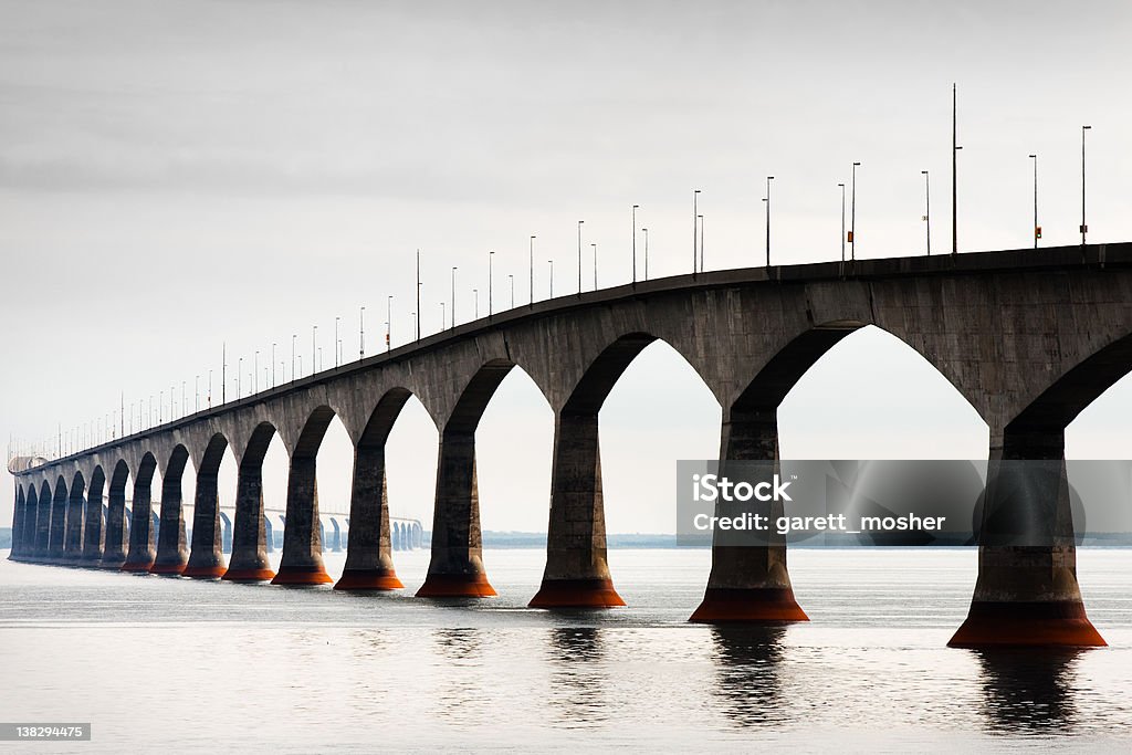 Confederation Bridge on hot hazy overcast day The confederation bridge spans the northumberland straight from prince edward island to new brunswick, taken from the Prince Edward Island side. Bridge - Built Structure Stock Photo