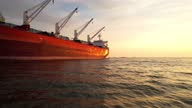 istock AERIAL Large cargo ship sailing the sea at sunset 1382948191