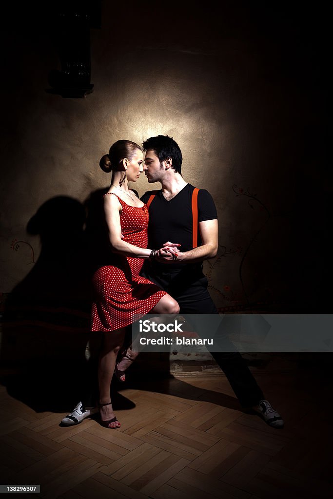 Portrait of couple dancing tango in red and black Beautiful dancers performing an Argentinian tango. Please check similar images from my portfolio. Elegance Stock Photo