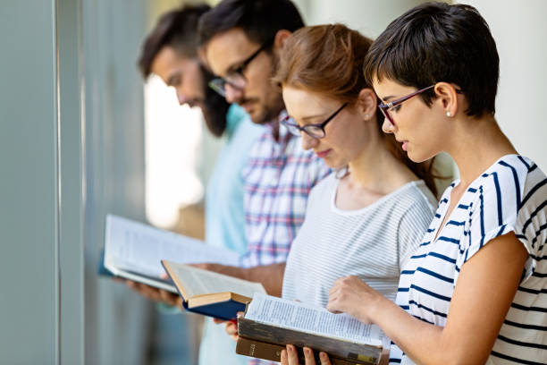 istock Happy group of students studying and working together in a college library 1382979927