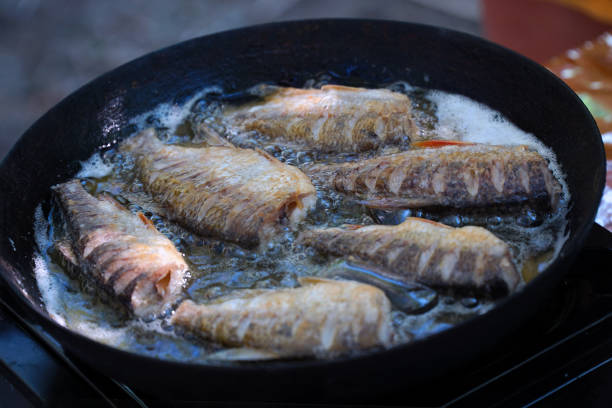 istock Small river fish is fried on a hike or fishing in camp pan 1382980355