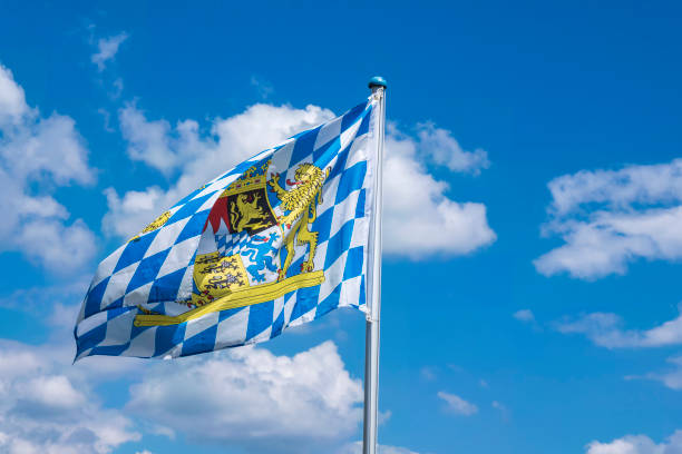 Waving Bayern flag View of a Bavarian flag waving in the wind in front of a white-blue sky bavaria stock pictures, royalty-free photos & images