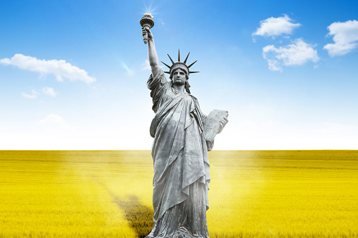 The Statue of Liberty symbol of peace against the background of the Ukrainian flag