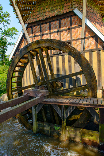 Hüvener Mühle old combined windmill and watermill in Hüven, Germany during a beautiful summer day.