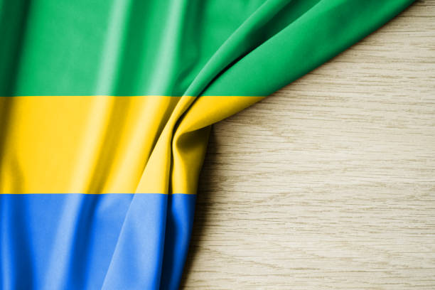 istock Gabon flag. Fabric pattern flag of Gabon. 3d illustration. with back space for text. 1382989351