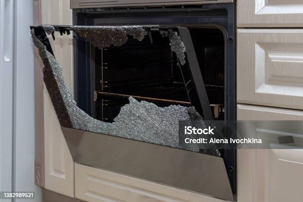 Opened Broken Oven Door In The Kitchen Side View Closeup Broken Glass From Overheating Broken Glass From Impact Stock Photo - Download Image Now