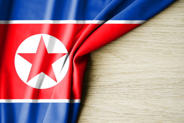istock North Korea flag. Fabric pattern flag of North Korea. 3d illustration. with back space for text. 1382989724