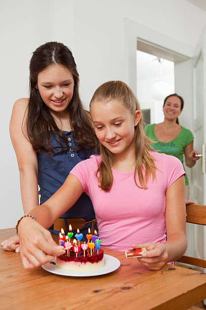 menina de velas no bolo de aniversário - fire match women flame imagens e fotografias de stock