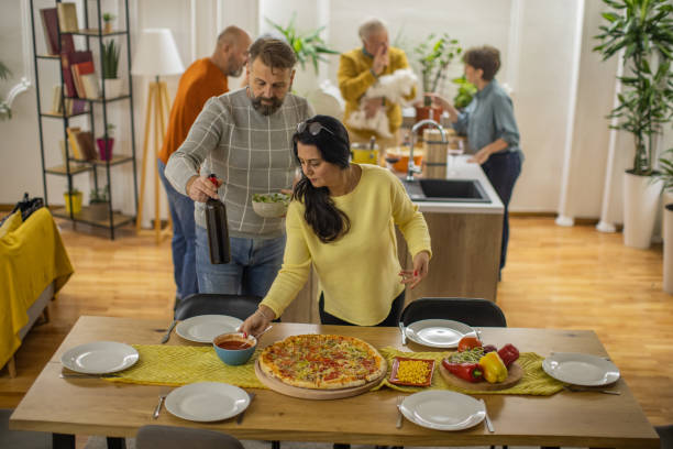 istock Caucasian friends set the meal on the table 1383006526