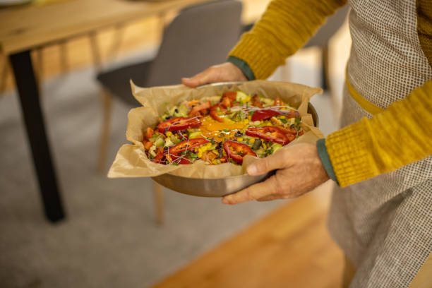 istock Unrecognizable male chef, holding the baking pan with homemade pizza 1383007767