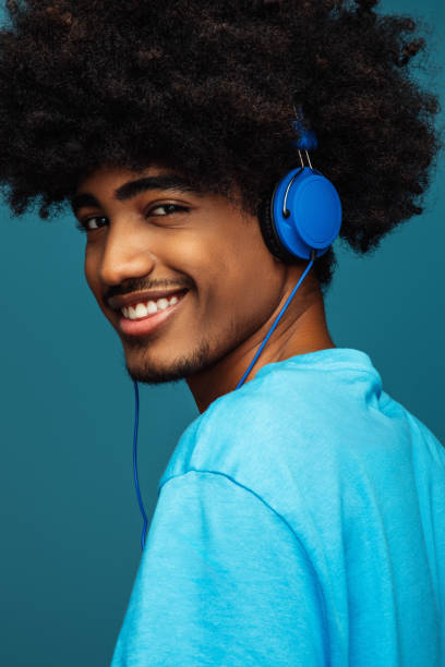 istock African american man with african hairstyle using phone 1383008277