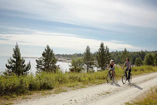 Photo of Couple bicycling on rural dirt path