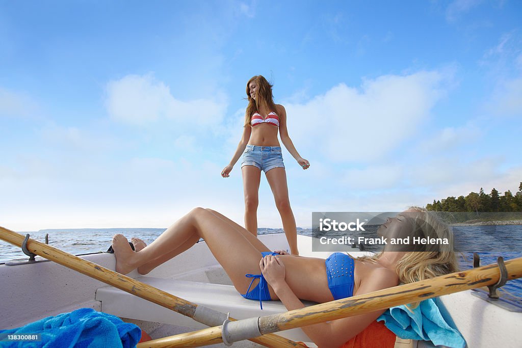 Teenage girls relaxing on sailboat  Sweden Stock Photo