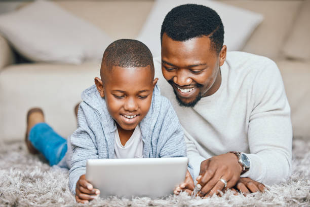 istock Shot of a little boy using a digital tablet at home 1383009165