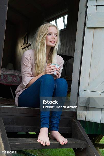 Teenage Girl Having Coffee On Doorstep Stock Photo - Download Image Now - Sitting, Staircase, Teenage Girls