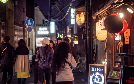 26 march 2019 - Kyoto, Japan: Narrow alley street in Gion district at night with people and illuminated restaurant buildings